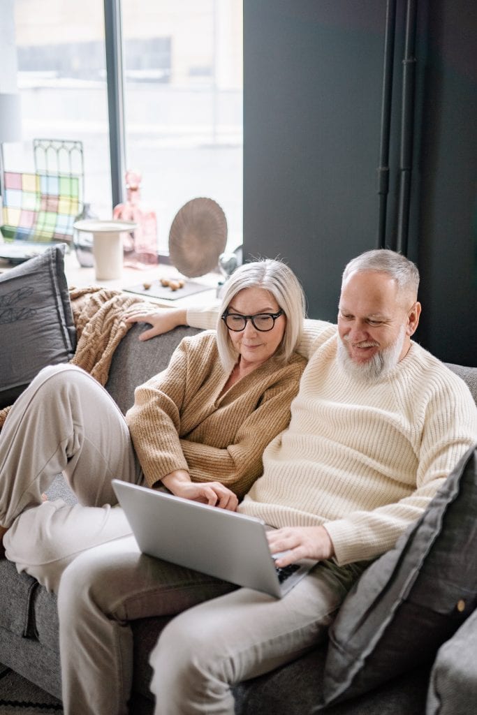 A couple watching videos for tips on staying up to date with advancing technology trends.